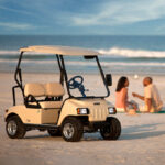 Couple enjoying a beach date near a parked Villager cart in Nassau, Bahamas