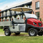 Red Carryall golf car parked in front of a building in Nassau, Bahamas