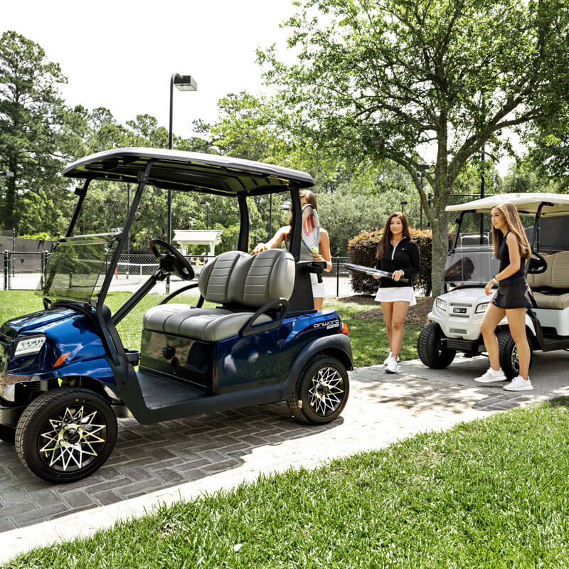Blue and White Golf Carts Parked at Tennis Court